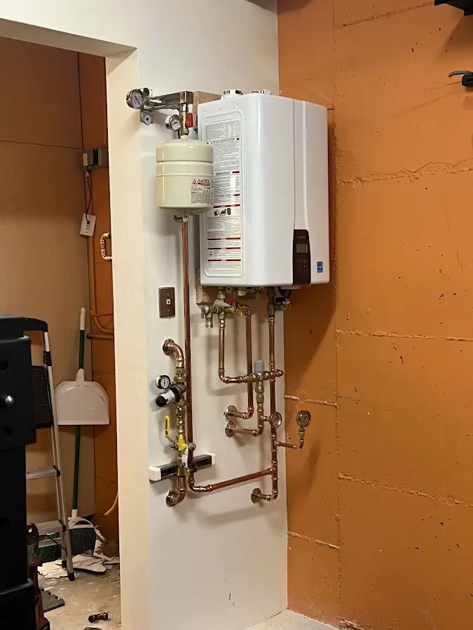 Plumbing technician inspecting water heater connections in Potomac